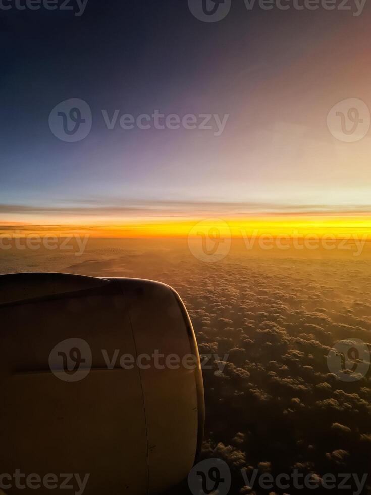 View of a beautiful sky from an airplane window at sunset. photo