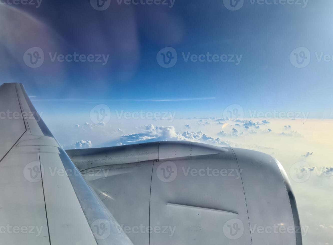 View from an airplane of the engine and the clouds over the Maldives. photo