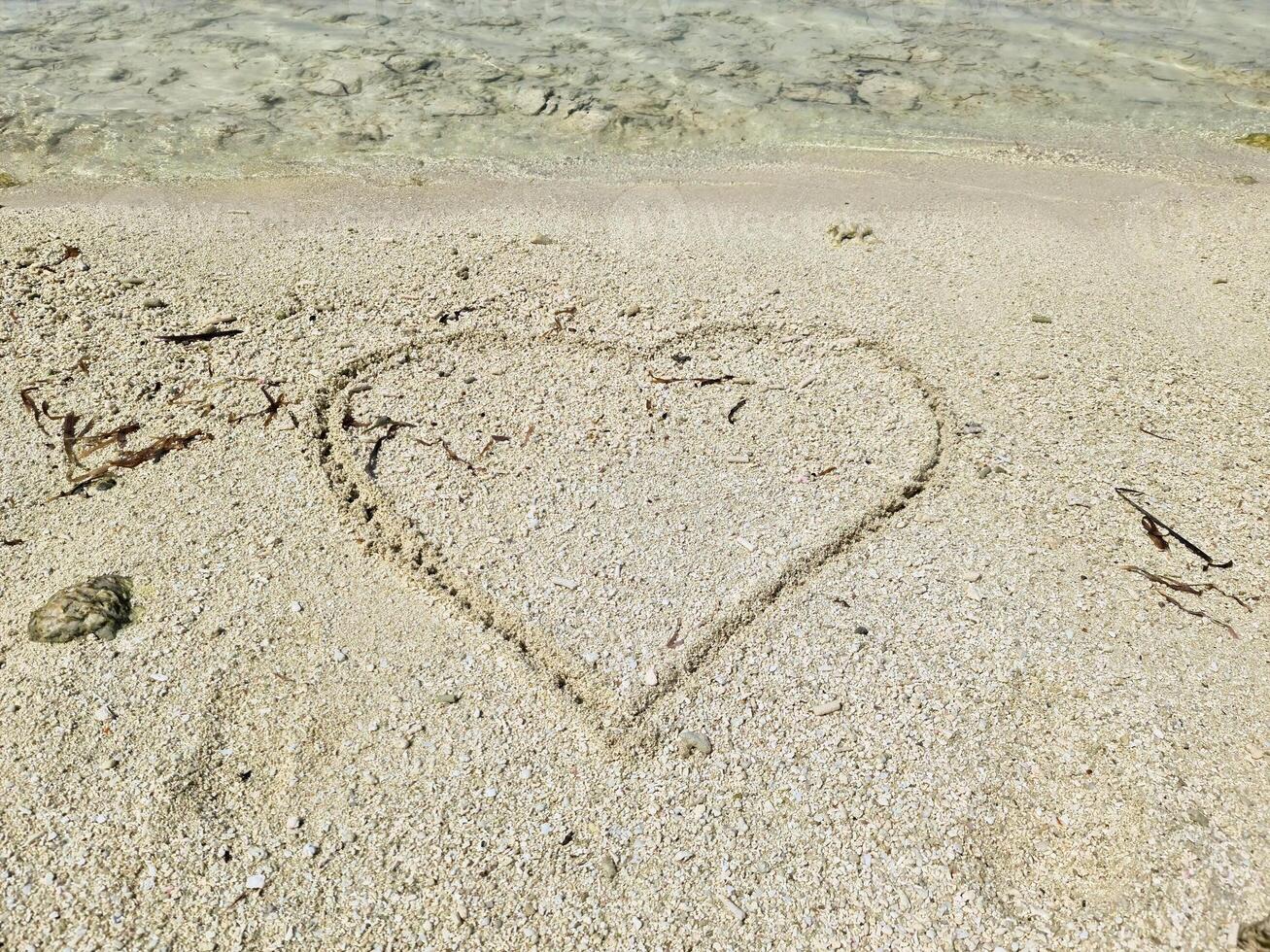 A romantic heart painted in the sand of the Maldives. photo