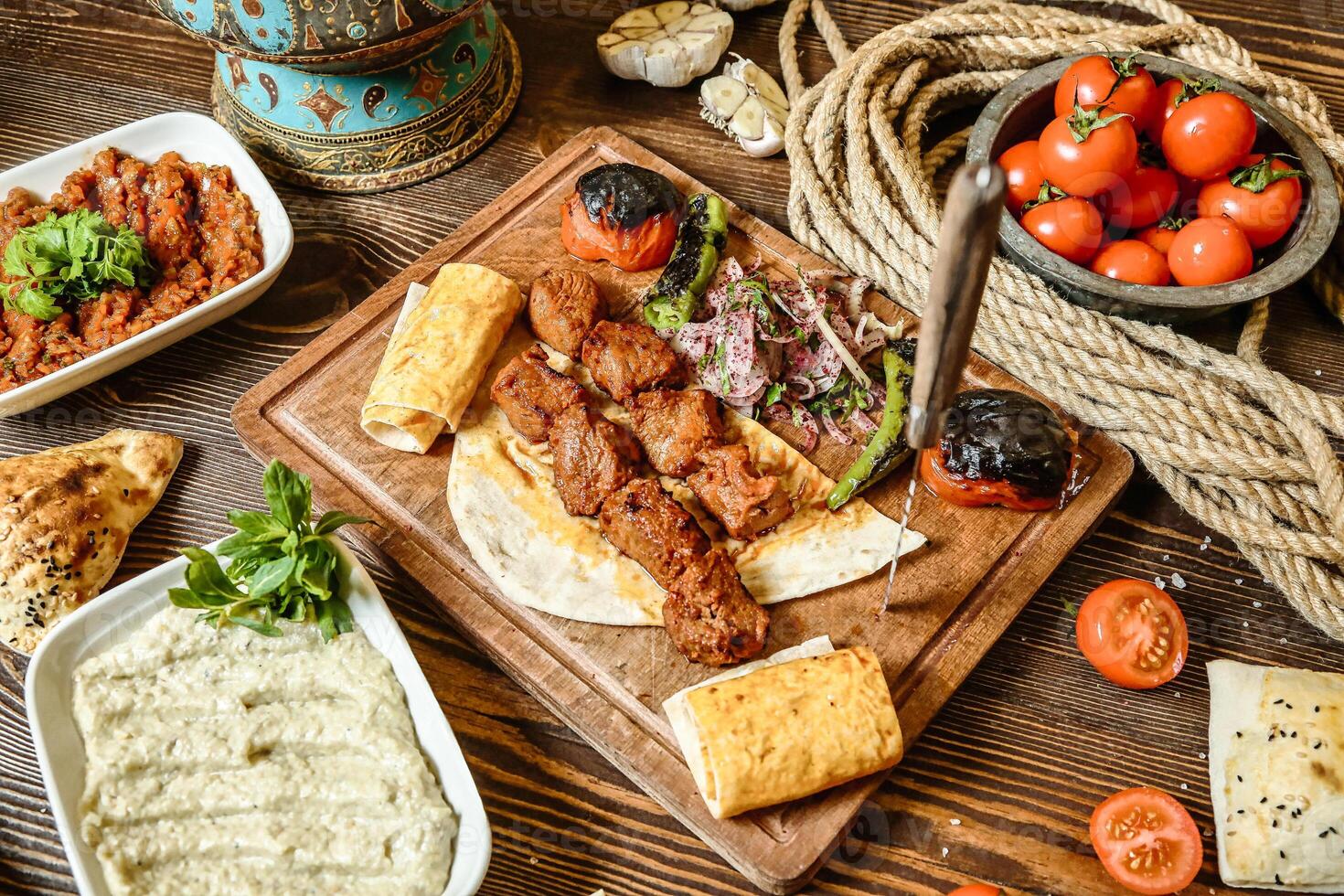 Wooden Table Displaying Variety of Delicious Food photo