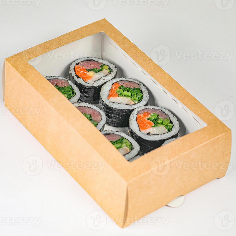 Sushi Rolls in Cardboard Box on White Surface photo