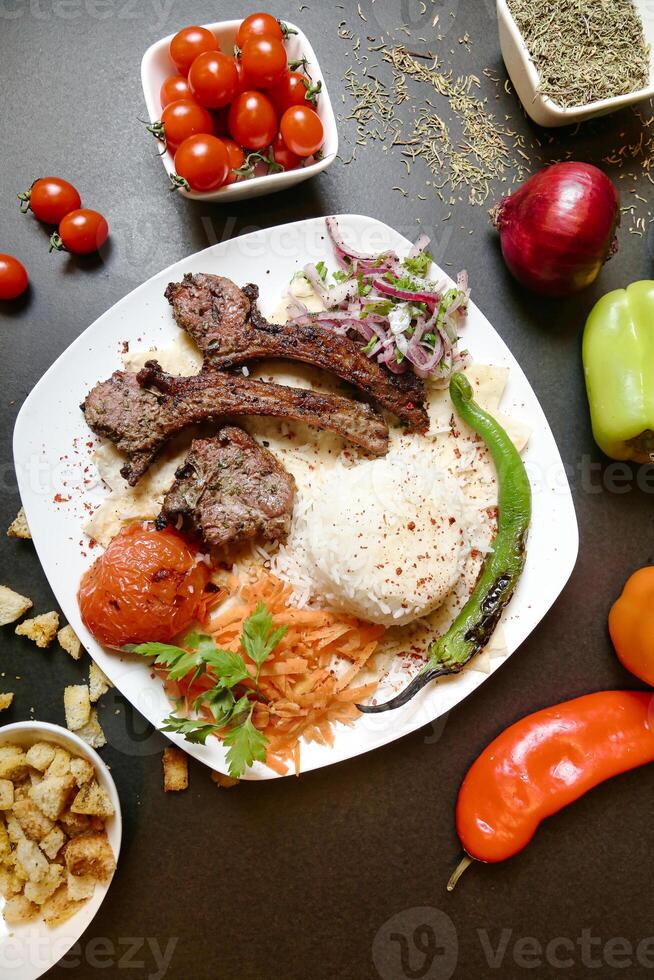 Plate of Meat and Vegetables on Table photo