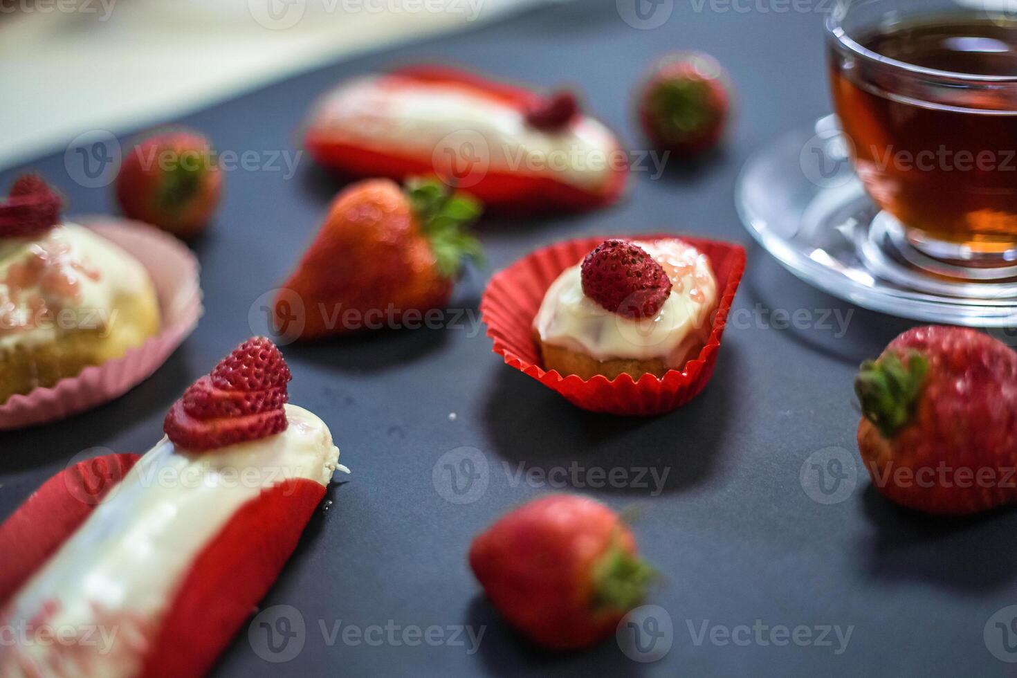 Red and White Desserts on Table With Cup of Tea photo