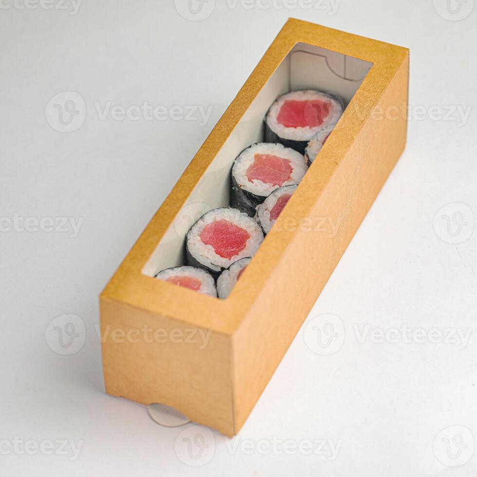 Wooden Box Filled With Sushi on White Table photo