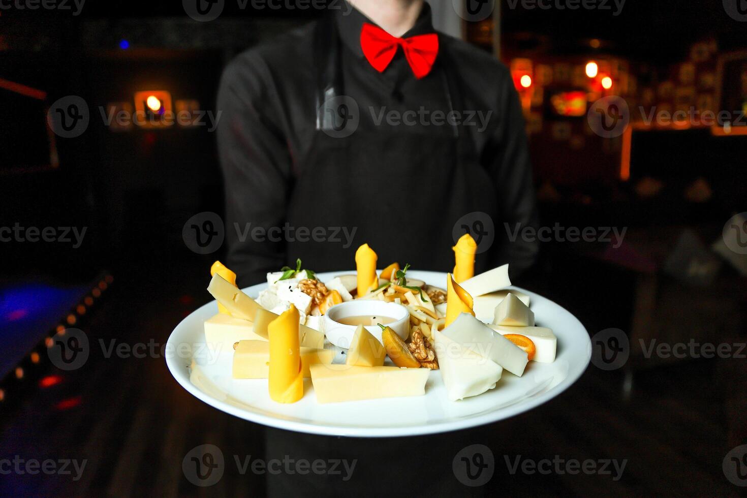 Waiter Holding a Plate of Food in a Restaurant photo
