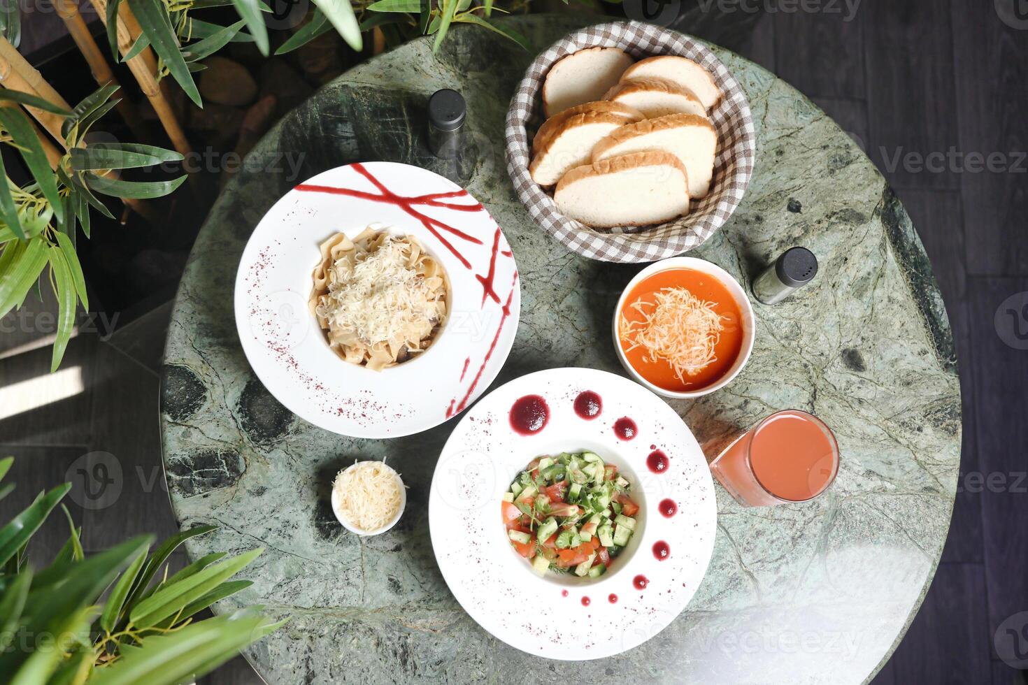 Table Displaying Assorted Plates of Food and Drinks photo