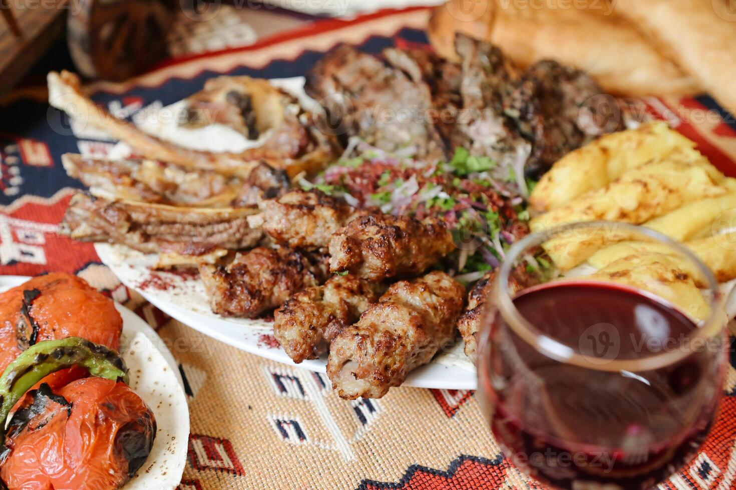 Table With Food Plates and Glass of Wine photo