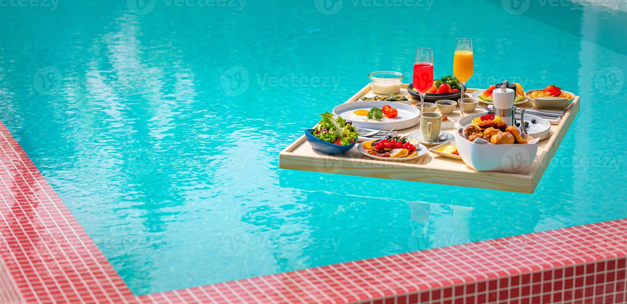 Breakfast in swimming pool, floating breakfast in luxurious tropical resort. Table relaxing on calm pool water, healthy breakfast and fruit plate by resort pool. Tropical couple beach luxury lifestyle photo