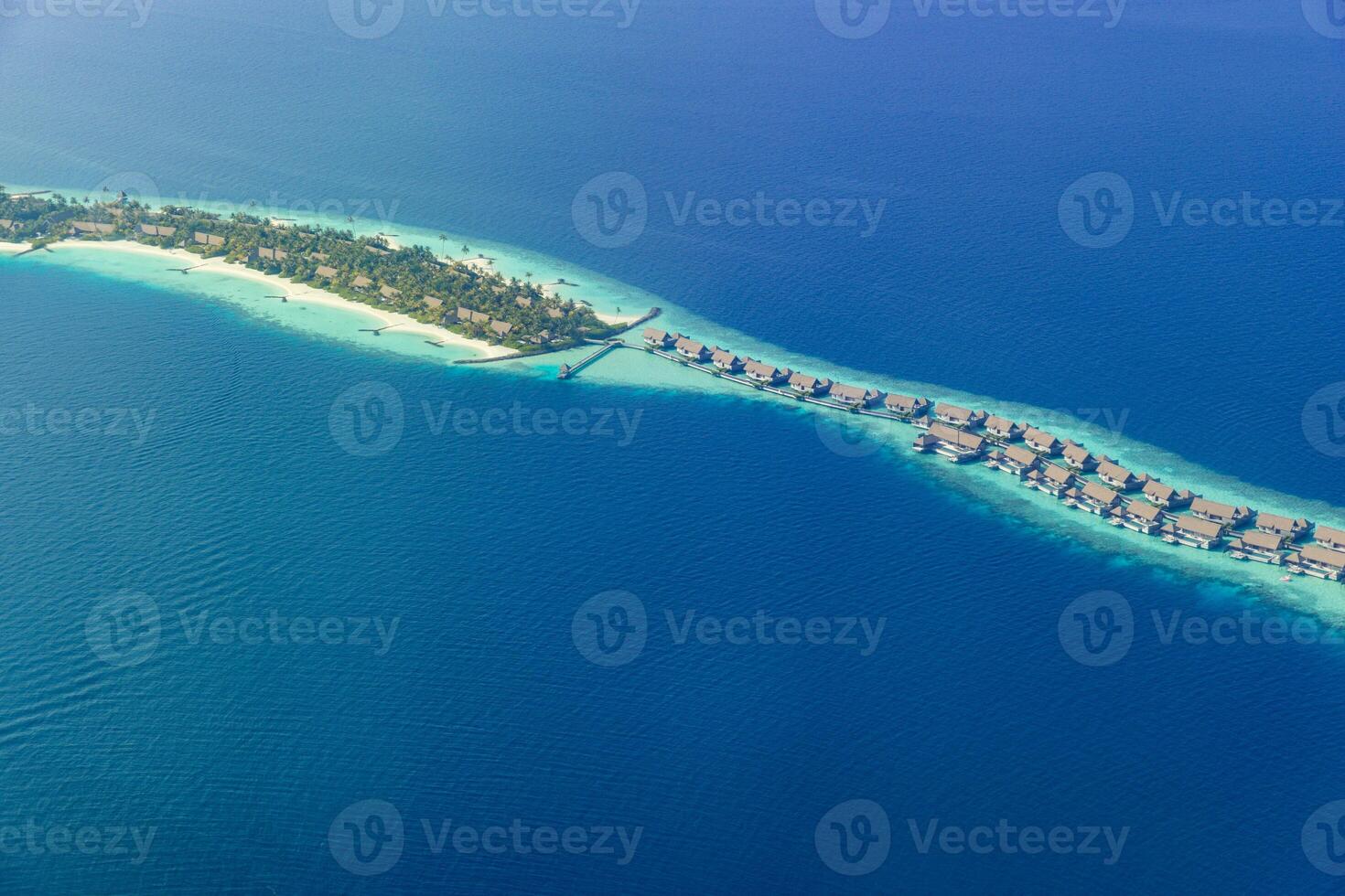 Fantastic aerial landscape, luxury tropical resort or hotel with water villas and beautiful beach scenic. Amazing bird eyes view in Maldives, landscape seascape aerial view over Maldives, traveling photo