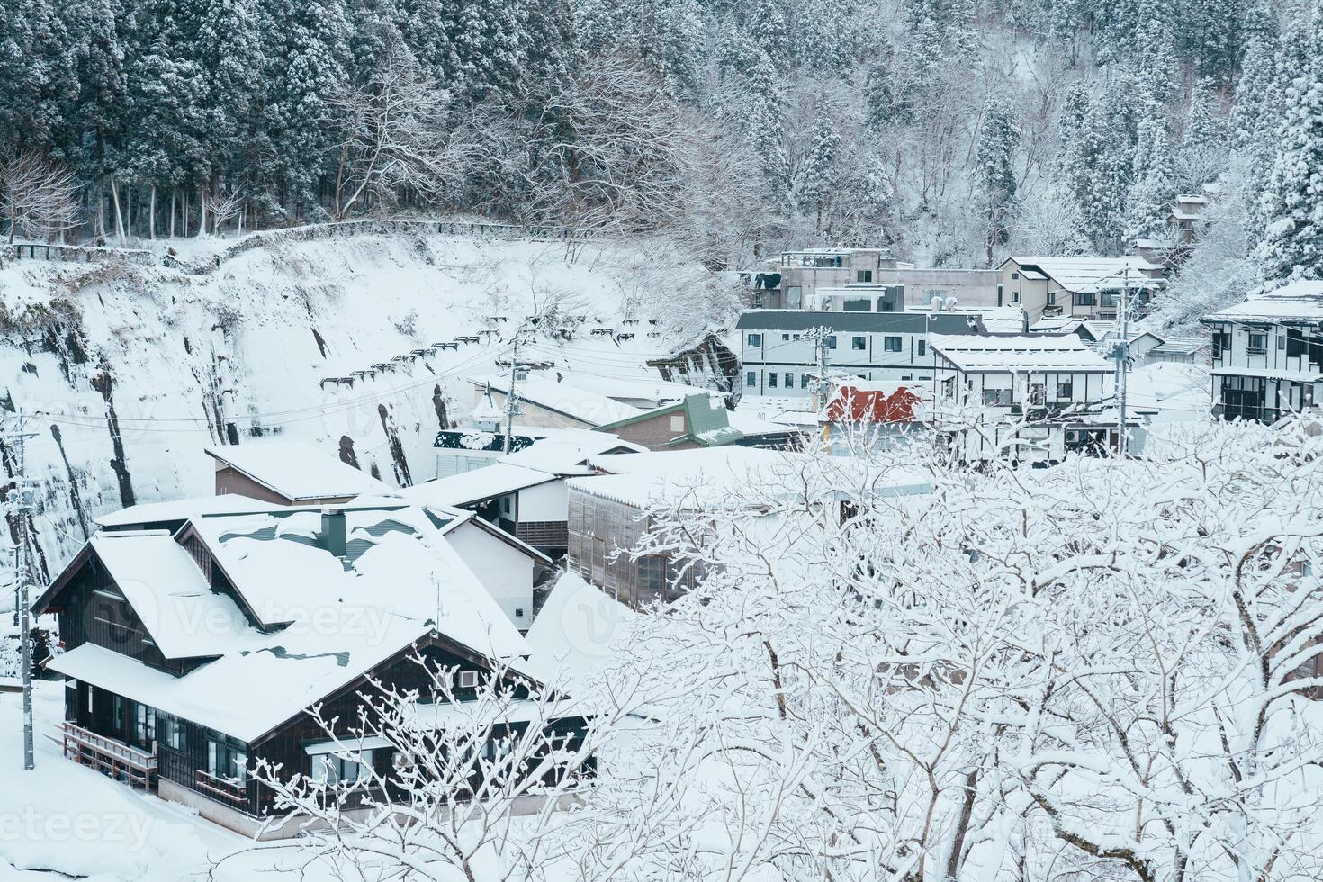 Beautiful view of Ginzan Onsen village with snow fall in winter season is most famous Japanese Hot Spring in Yamagata, Japan. photo