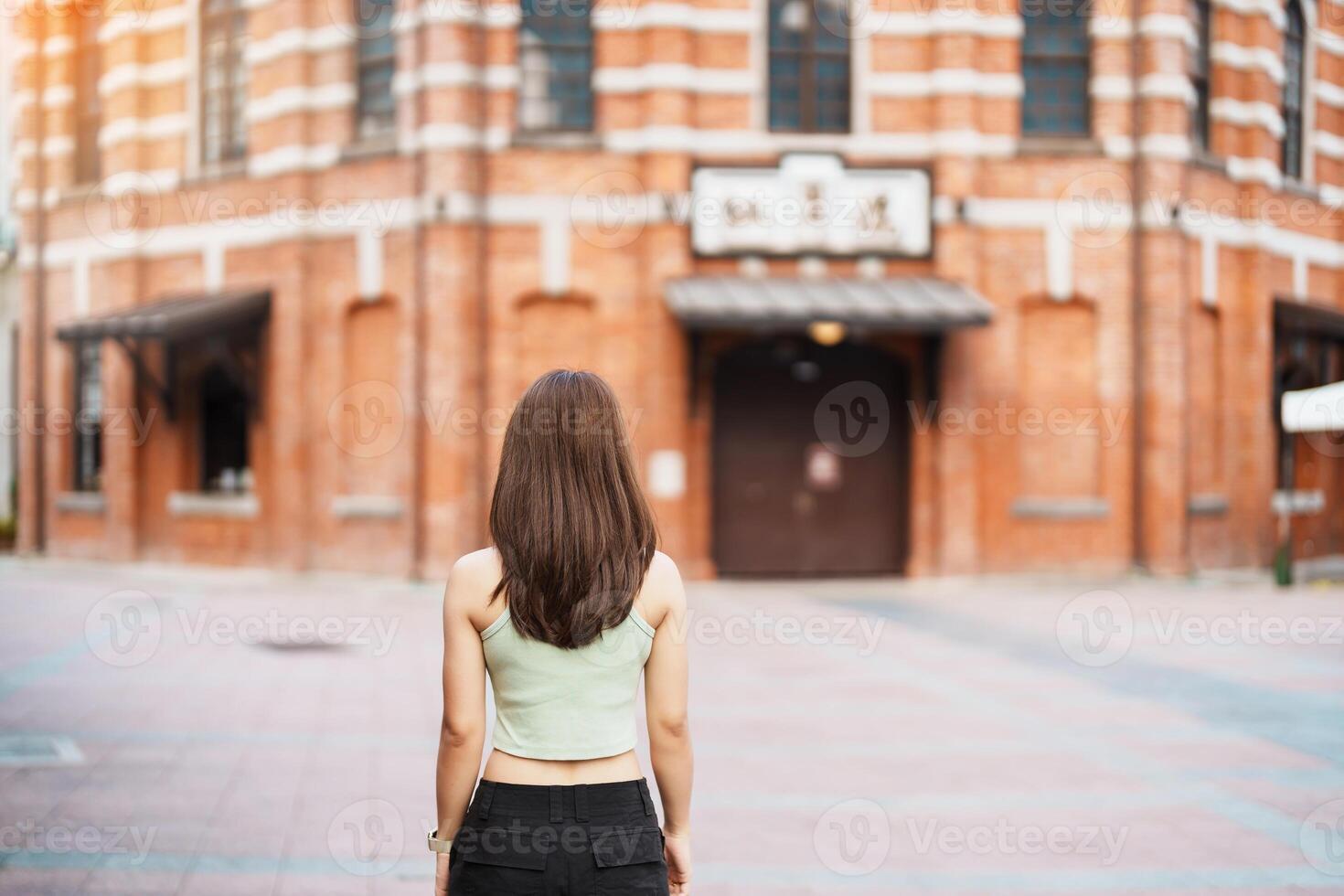 woman traveler visiting in Taiwan, Tourist sightseeing at Red House or old theater in Ximen, Taipei City. landmark and popular attractions. Asia Travel, Trip and Vacation concept photo