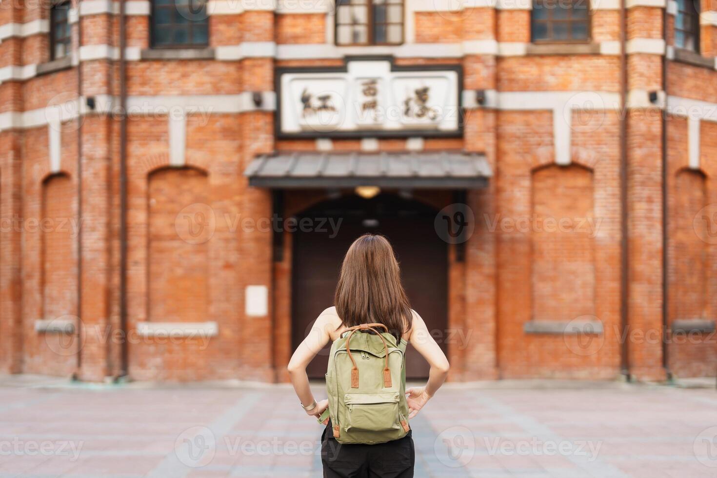 woman traveler visiting in Taiwan, Tourist sightseeing at Red House or old theater in Ximen, Taipei City. landmark and popular attractions. Asia Travel, Trip and Vacation concept photo