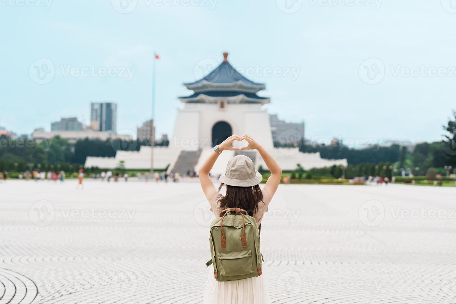 woman traveler visiting in Taiwan, Tourist with backpack sightseeing in National Chiang Kai shek Memorial or Hall Freedom Square, Taipei City. landmark and popular attractions. Asia Travel concept photo