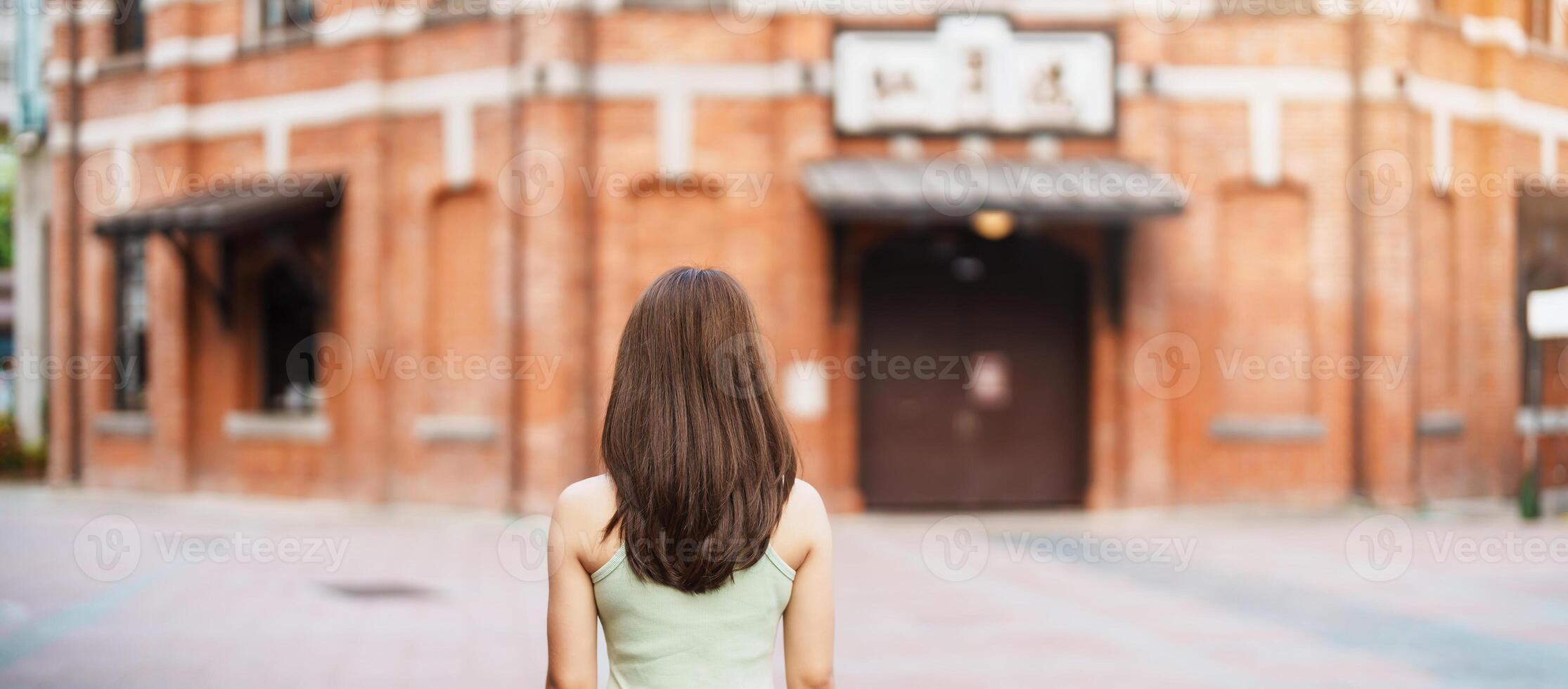 woman traveler visiting in Taiwan, Tourist sightseeing at Red House or old theater in Ximen, Taipei City. landmark and popular attractions. Asia Travel, Trip and Vacation concept photo