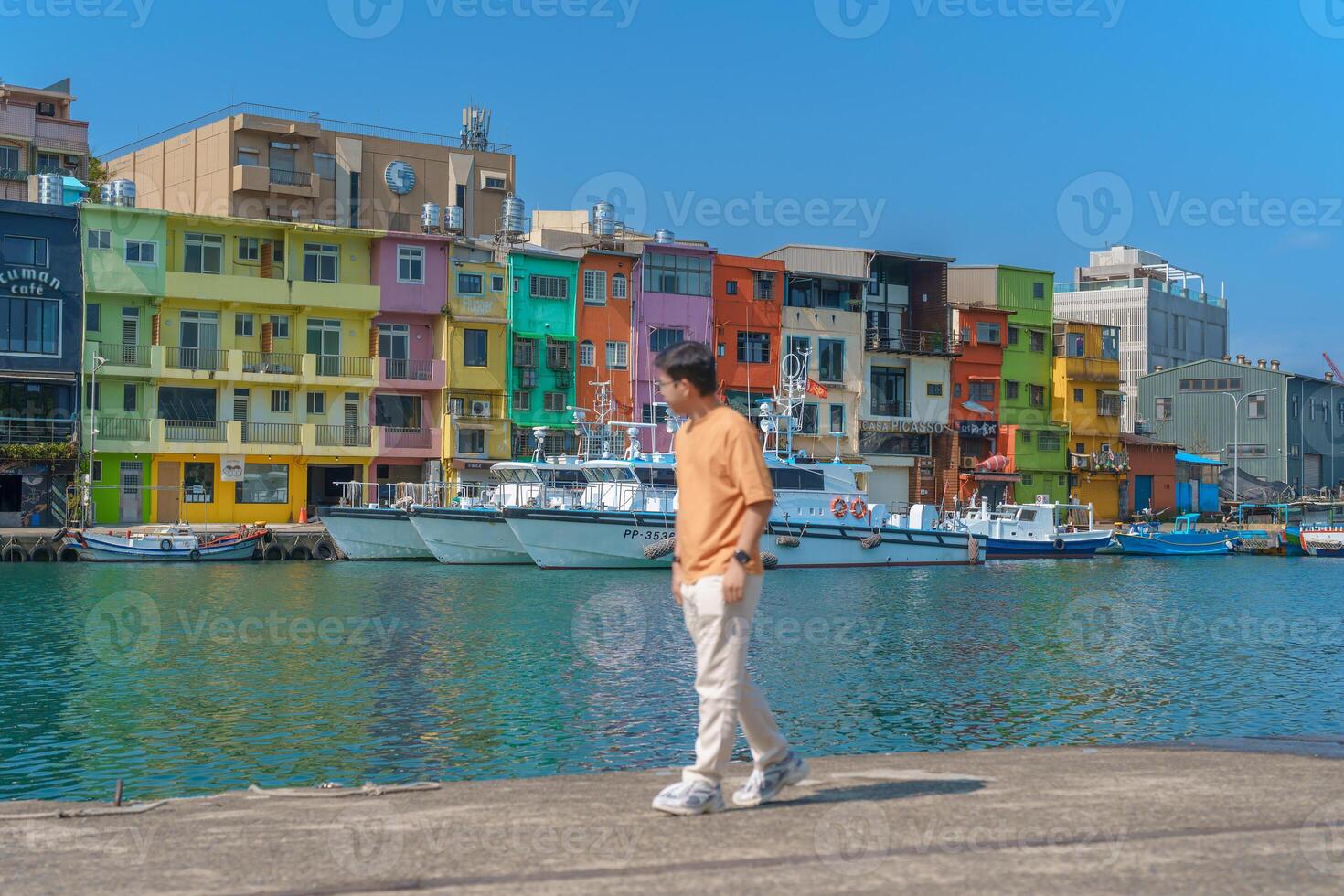 man traveler visiting in Taiwan, Tourist sightseeing in Keelung, Colorful Zhengbin Fishing Port, landmark and popular attractions near Taipei city . Asia Travel concept photo