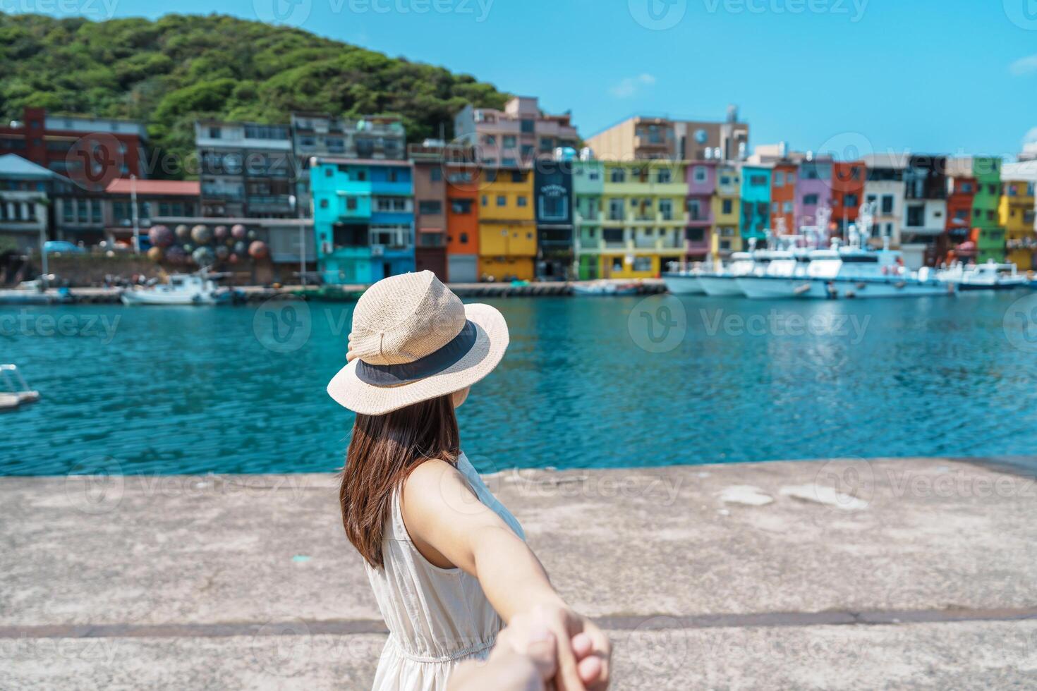 Couple traveler visiting in Taiwan, Tourist sightseeing in Keelung, Colorful Zhengbin Fishing Port, landmark and popular attractions near Taipei city. trip, love, together and summer vacation concept photo