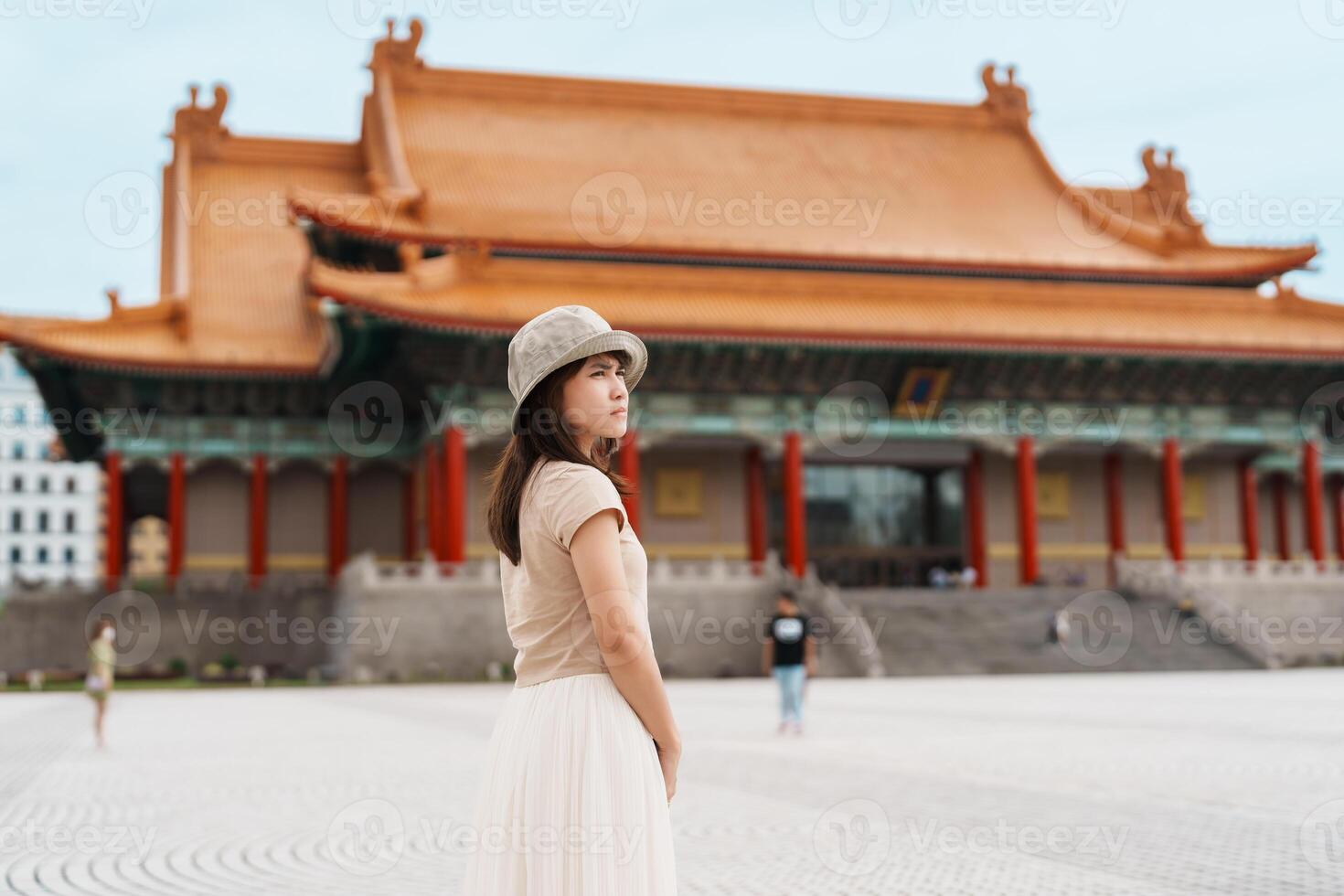 woman traveler visiting in Taiwan, Tourist with hat sightseeing in National Chiang Kai shek Memorial or Hall Freedom Square, Taipei City. landmark and popular attractions. Asia Travel concept photo