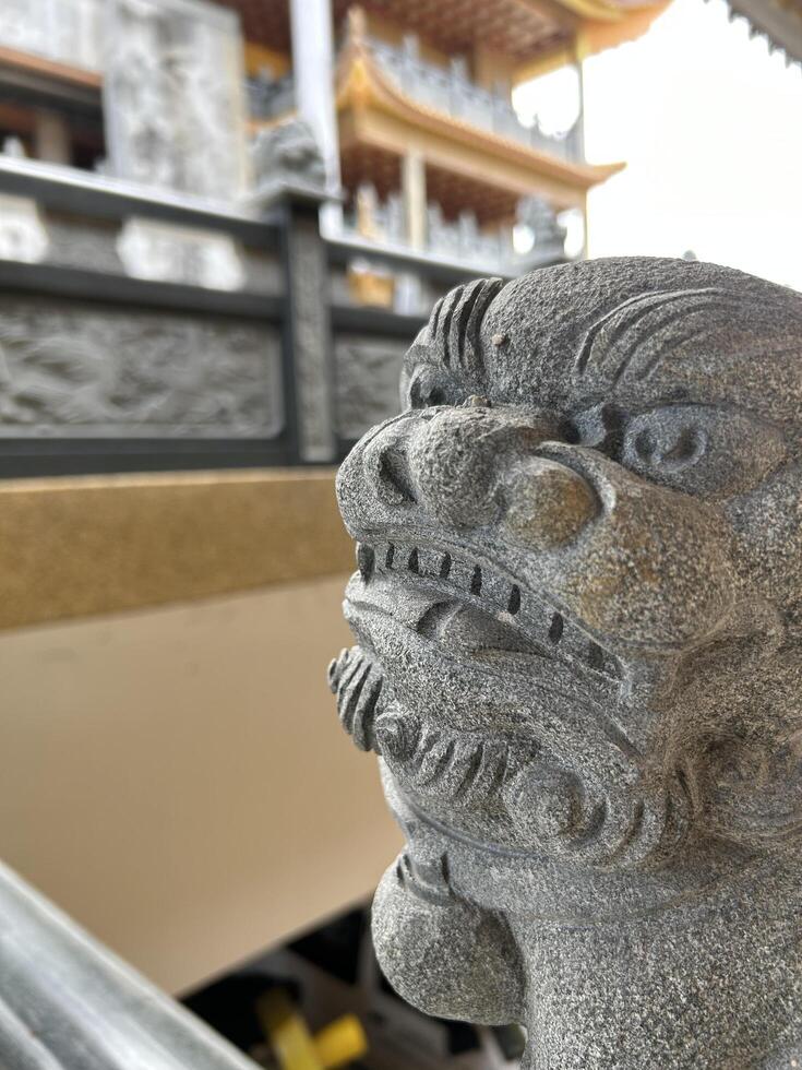 Stone Guardian Lion Sculpture at Traditional Chinese Temple photo