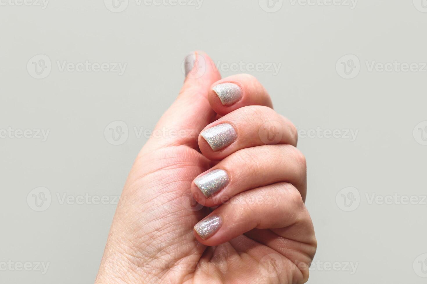 Shiny gel polish on nails, women's manicure. photo