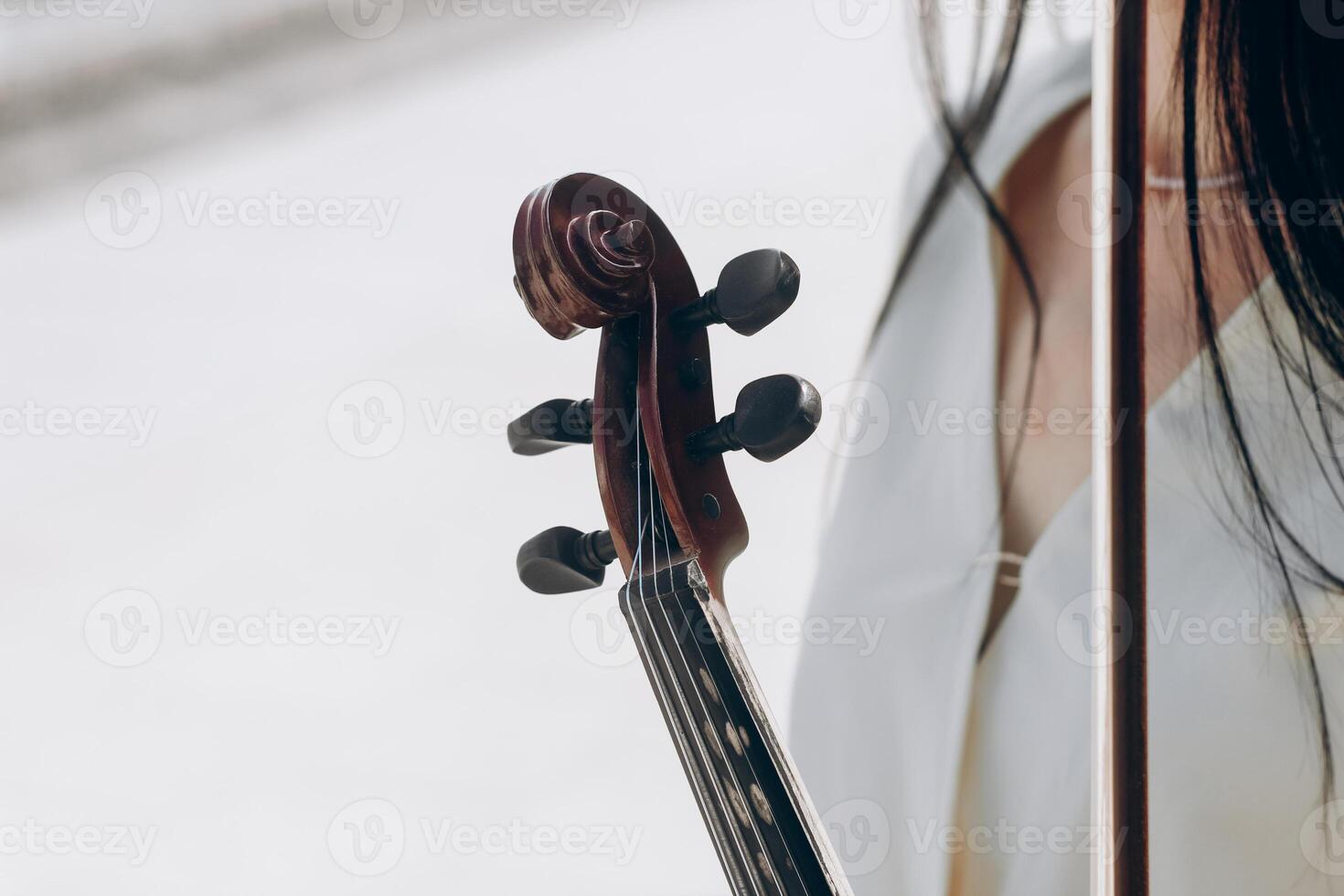 A fragment of an electric violin, a violin in the hands of a musician's girl photo