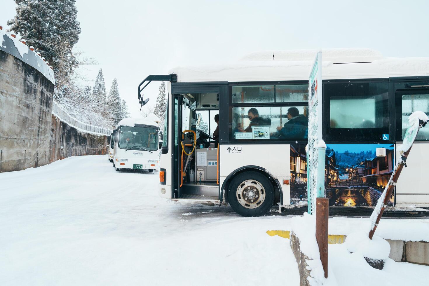 Bus stop at Ginzan Onsen for Oishida station with snow fall in winter season is most famous Japanese Hot Spring in Yamagata, Japan. Yamagata, Japan, 24 January 2024 photo