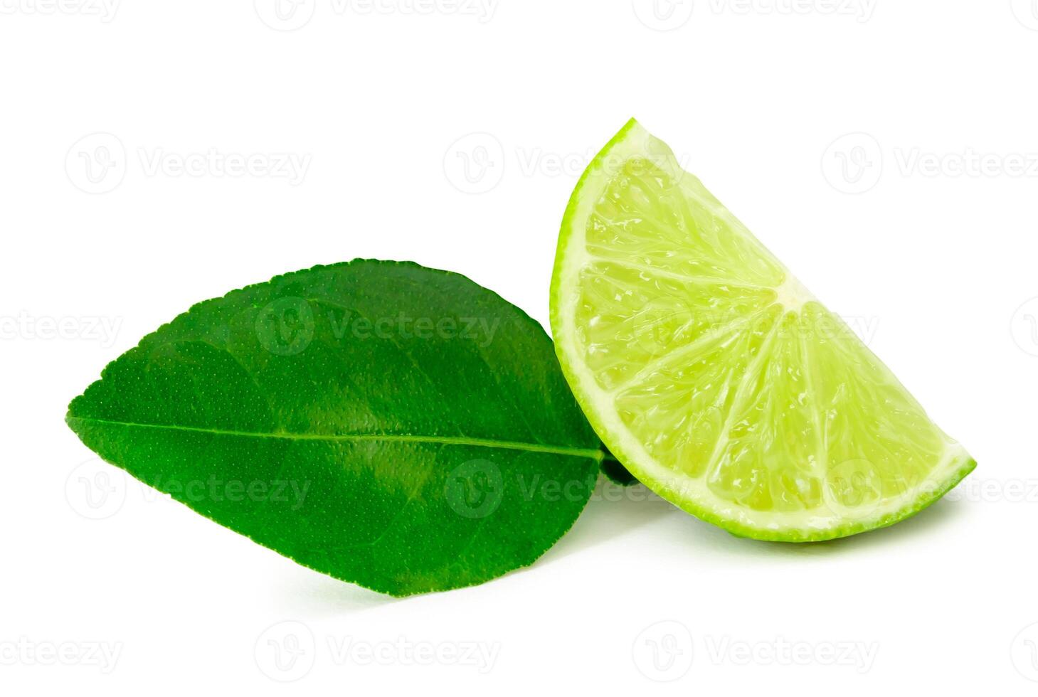 Front view of green lemon slice or quarter with leaf isolated on white background with clipping path photo