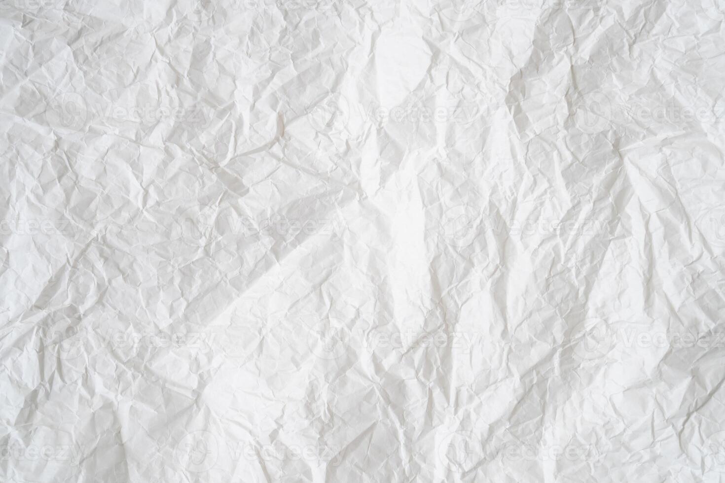 Wrinkled or crumpled white stencil paper or tissue after use with large copy space used for background texture photo