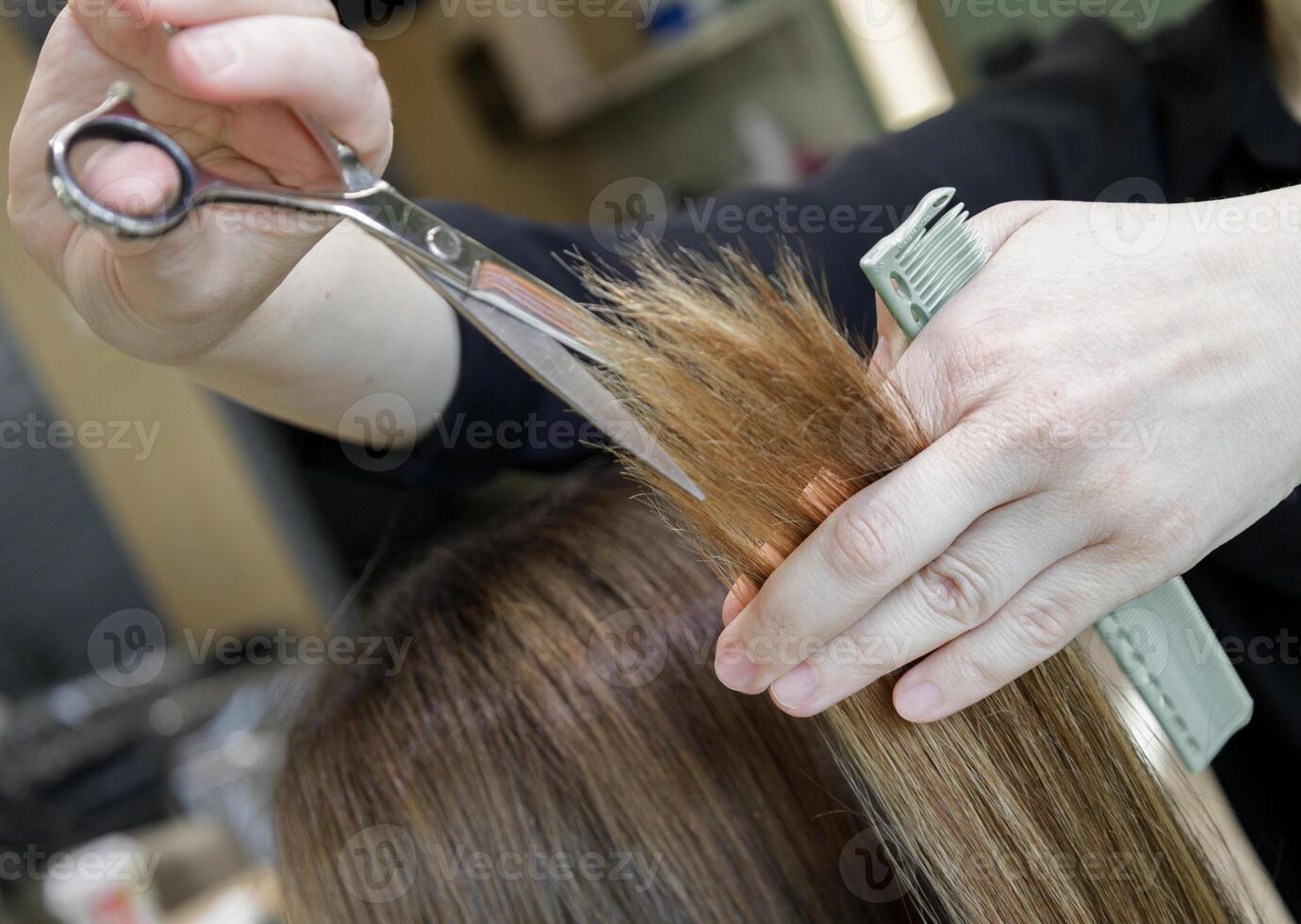 hairdresser's hands with scissors and a comb haircut client. selective focus.High quality photo