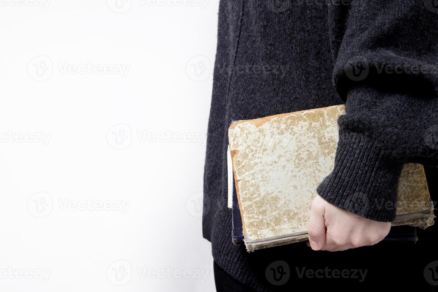 hands hold old books with textured paper and torn cover. vintage paper texture. selective focus. High quality photo
