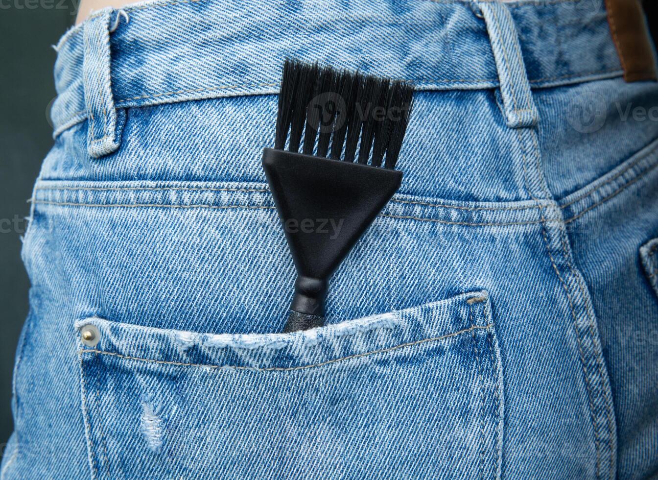 the hair dye brush is in the jeans pocket. High quality photo