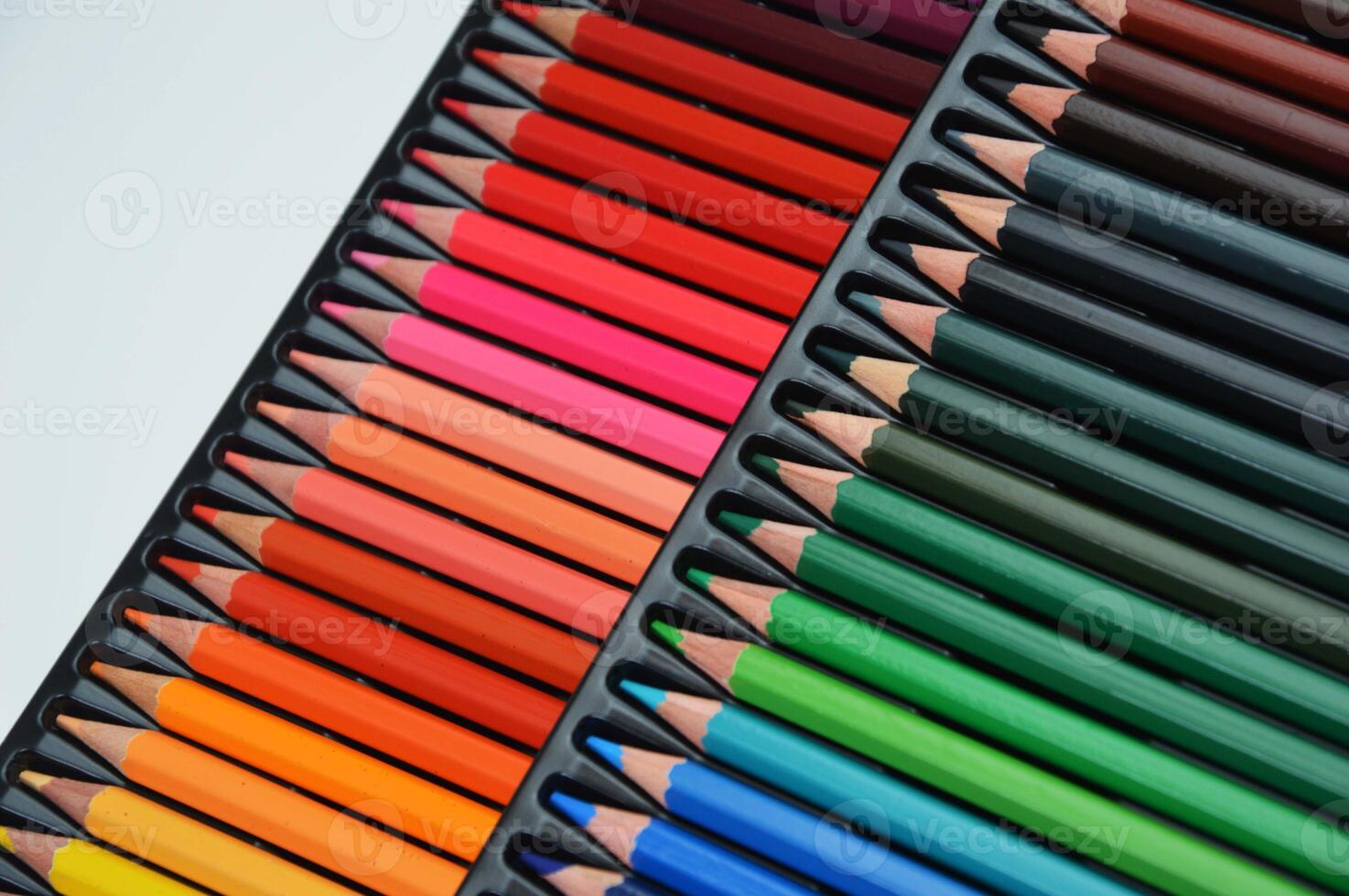 A row of colored pencils in a palette, lying in a line. Nice set. Tools for creativity, drawing, school, learning photo