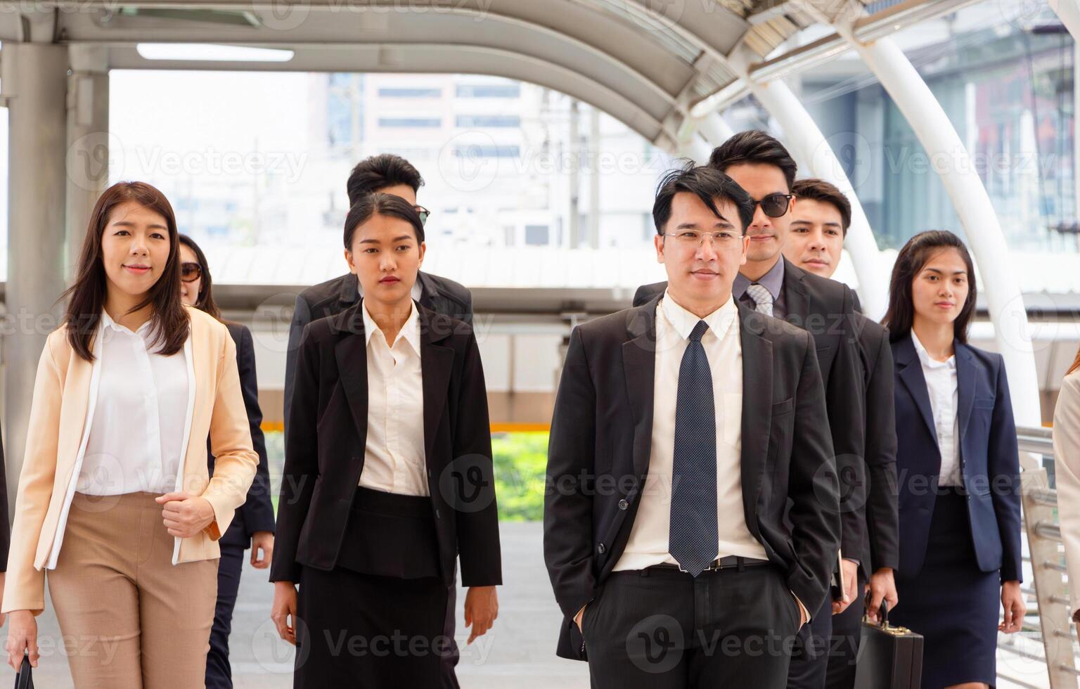 Group of happy young business team, businesspeople walking the outdoor office together success teamwork for concepts photo