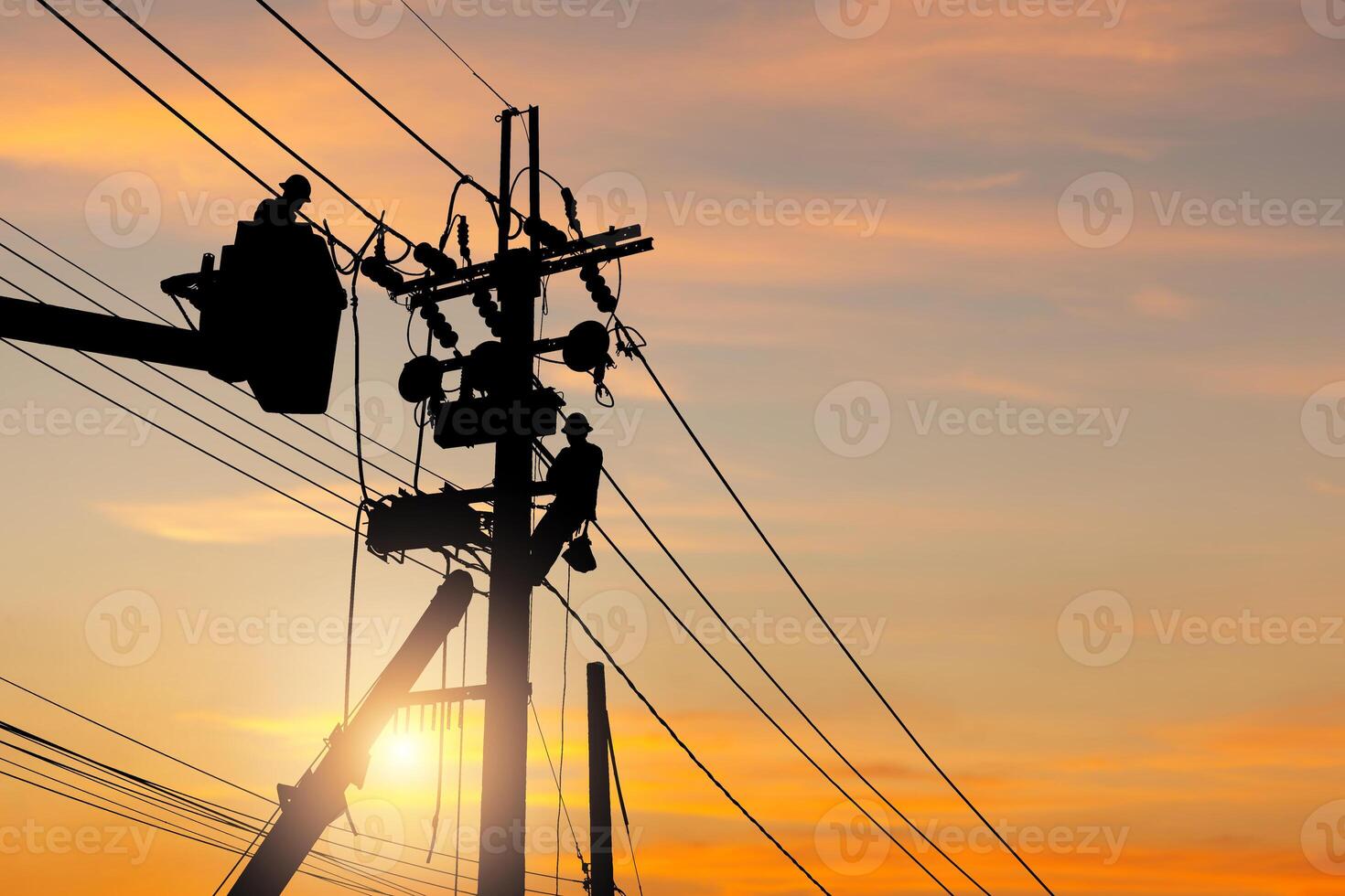Silhouette of Electrician officer team climbs a pole and using a cable car to maintain a high voltage line system, Electrician lineman repairman worker climbing work on the electric post power pole photo