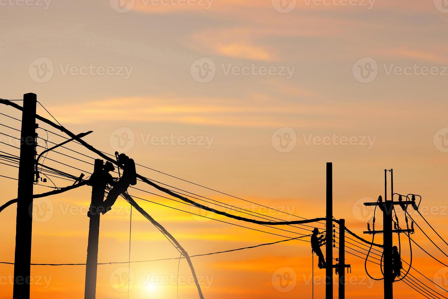 Silhouette of Electrician lineman worker at climbing work on the electric post power pole, Electrician checking lighting to the LED street lamp post photo