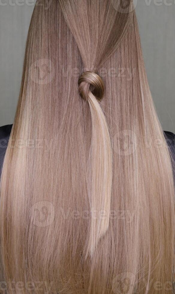 The model's beautiful hair is evenly styled and one strand is tied in a knot. selective focus.High quality photo
