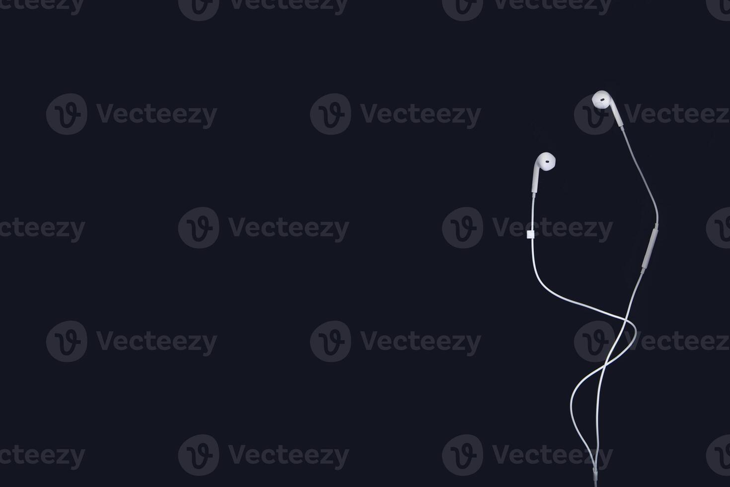 white headphones on a black background. Top view with copy space for text input photo