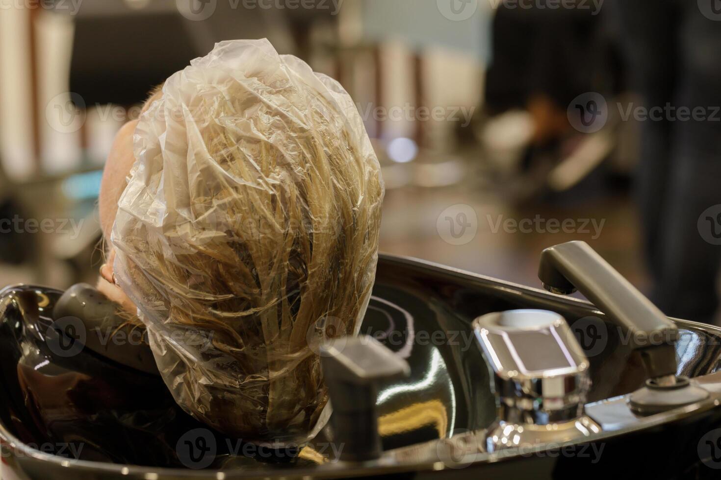 client s in beauty salon with hair mask in sink. High quality photo