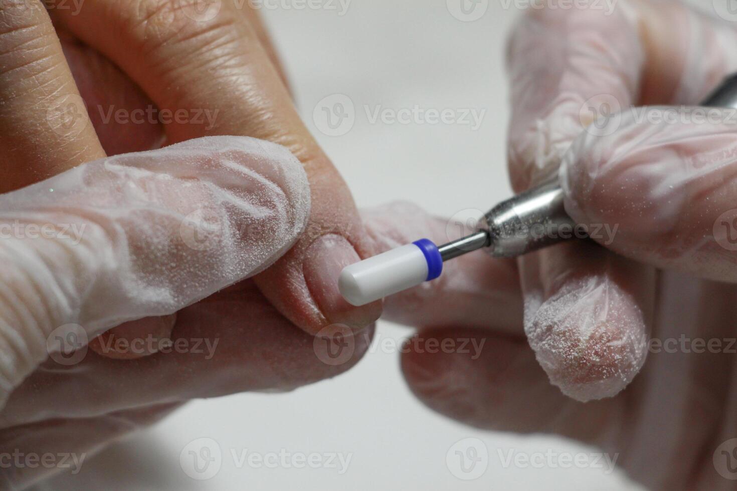 hands of the master in the beauty salon doing manicure to the client. selective focus.High quality photo