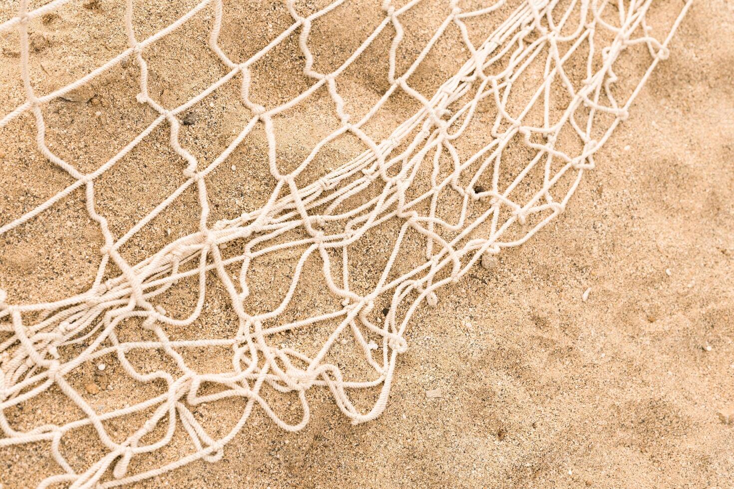 Fishnet on the sand. Fishnet. Woven mesh texture. High quality photo