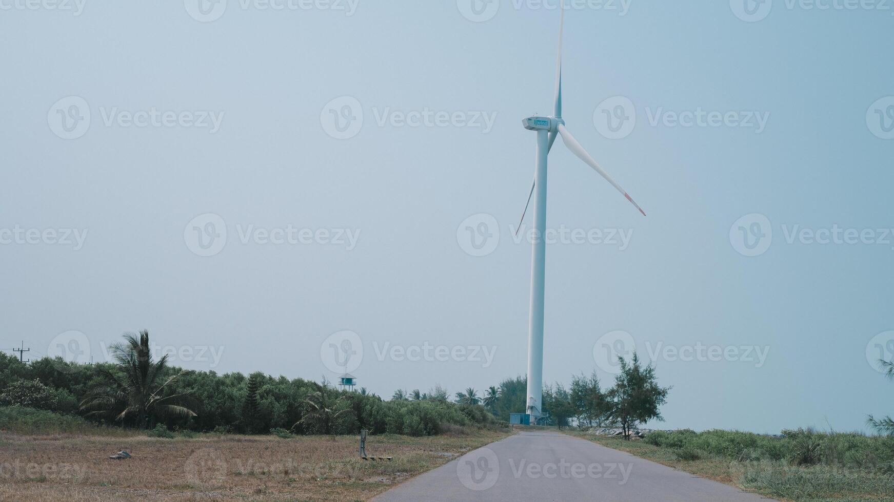 Windmill's turbine gracefully harnesses wind's power, converting it into electricity through generator. Sustainable technology exemplifies promise of renewable energy for greener, ecological future photo