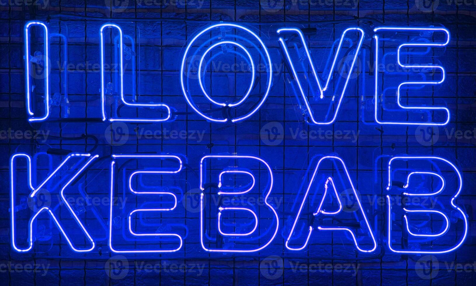 Neon shining sign in blue color on a brick wall with the inscription or slogan I love kebab. Brick wall, background. Bright electric neon light. Cafe-restaurant Doner Kebab. photo