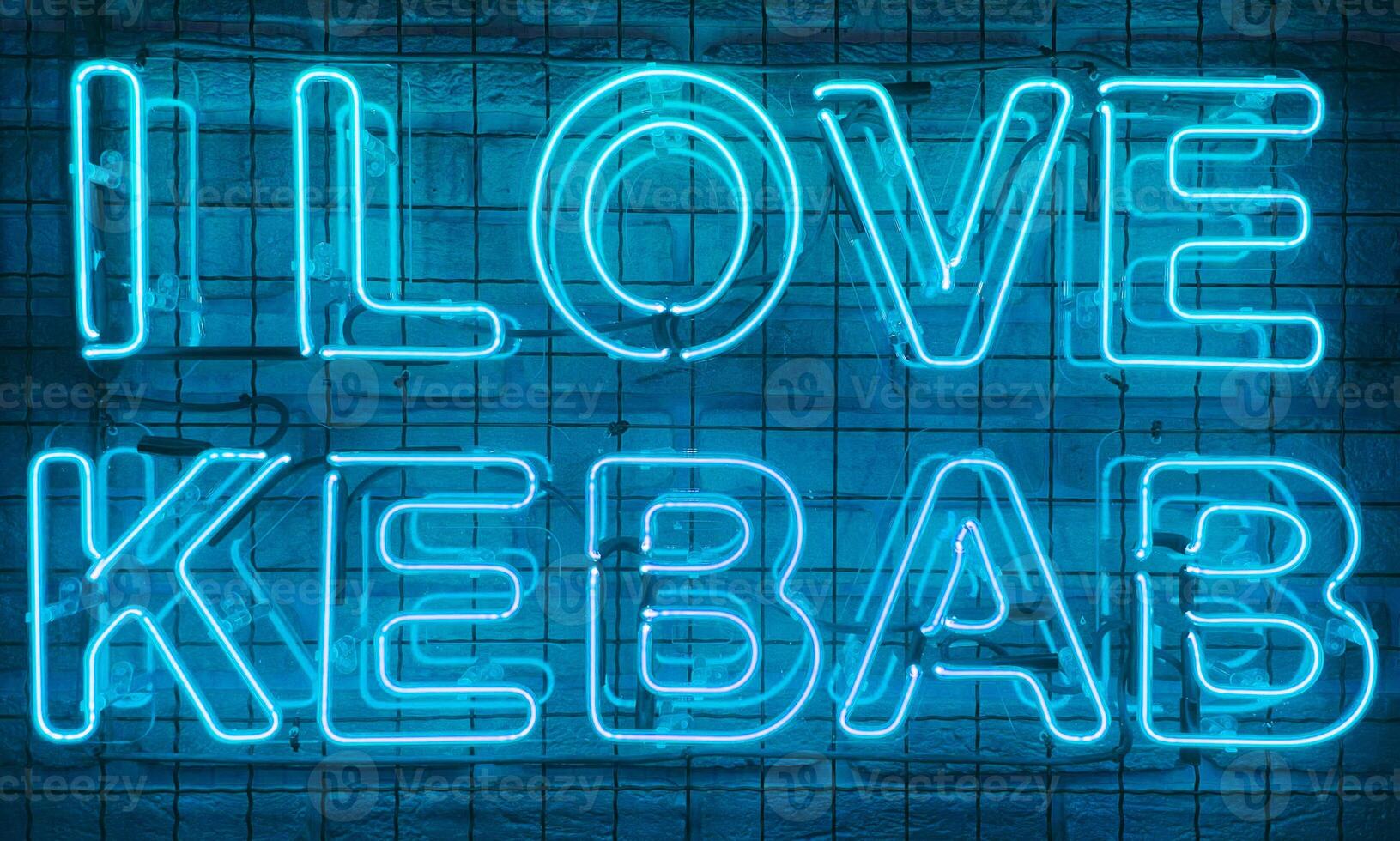 Neon shining sign in blue color on a brick wall with the inscription or slogan I love kebab. Brick wall, background. Bright electric neon light. Cafe-restaurant Doner Kebab. photo