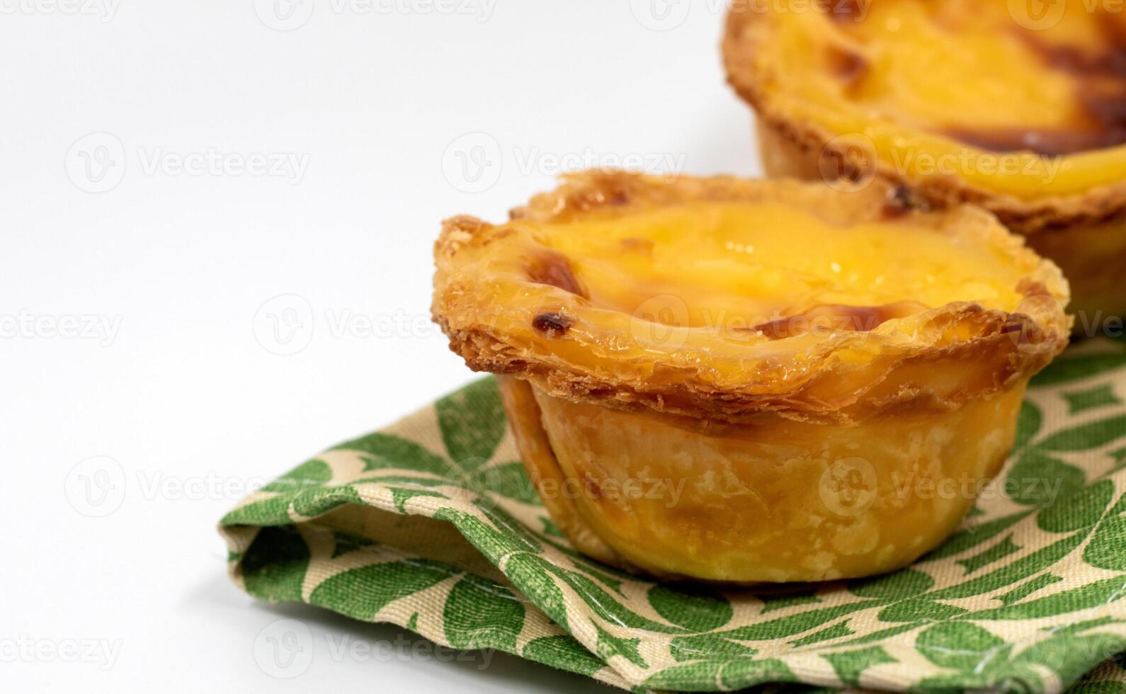 Lots of freshly baked desserts Pastel de nata or Portuguese egg tart. Pastel de Belm is a small pie with a crispy puff pastry crust and a custard cream filling. A small dessert, a cupcake. photo