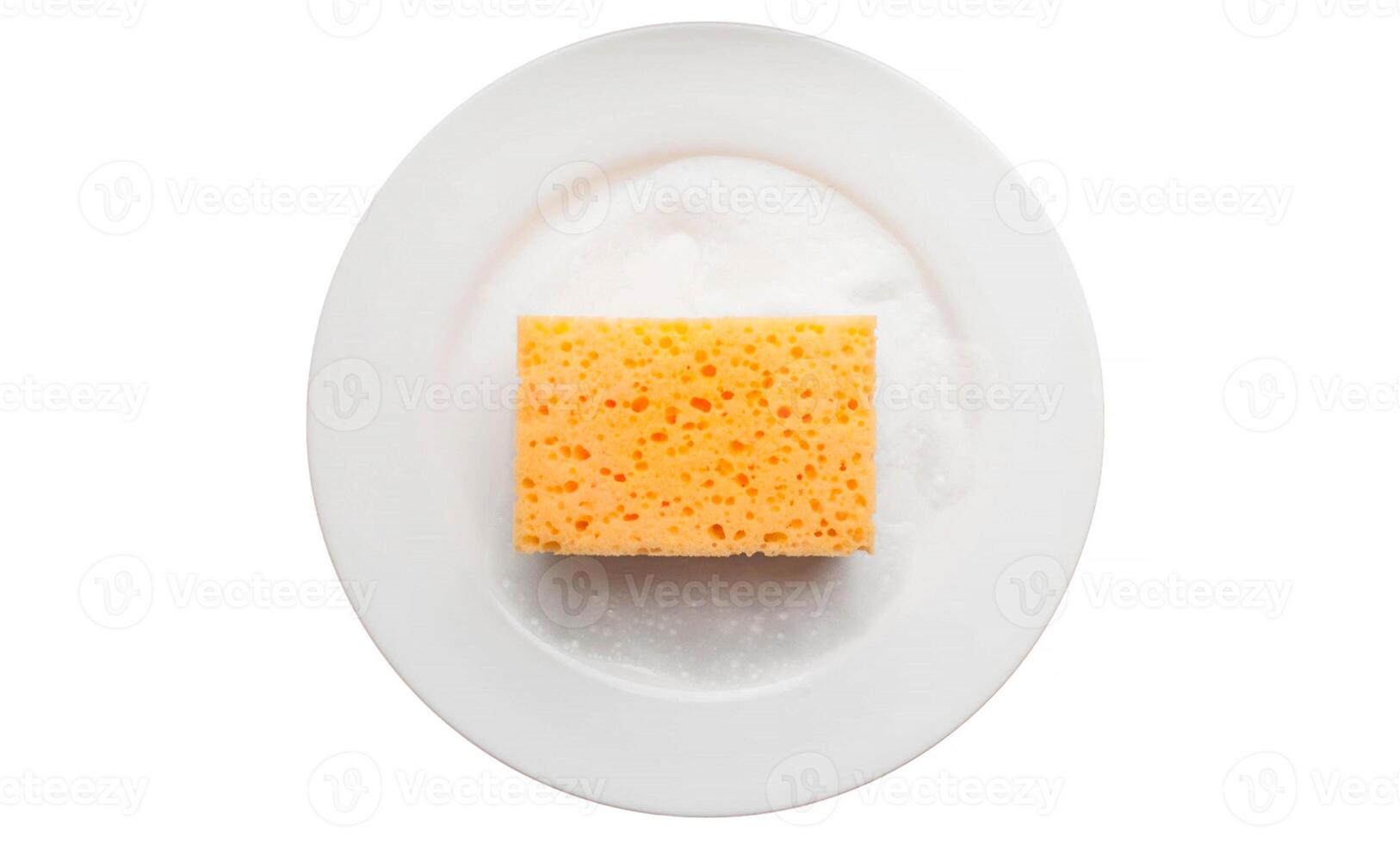 Cleaning yellow sponge on a white plate with soap foam isolated on a white background. Using a scrub sponge to scrub and wash food stains and dirt on white dishes after meals. Cleaning concept. photo