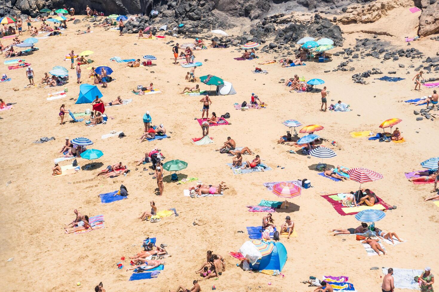 Lanzarote, Spain - August 15, 2018-people relaxing on one of the many beaches of Lanzarote during a summer day photo