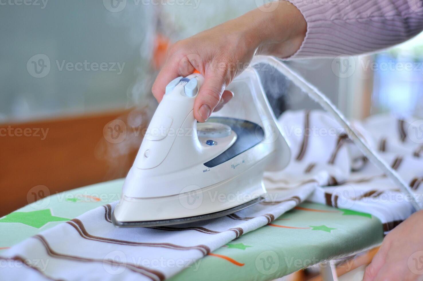 Woman hand Ironing photo