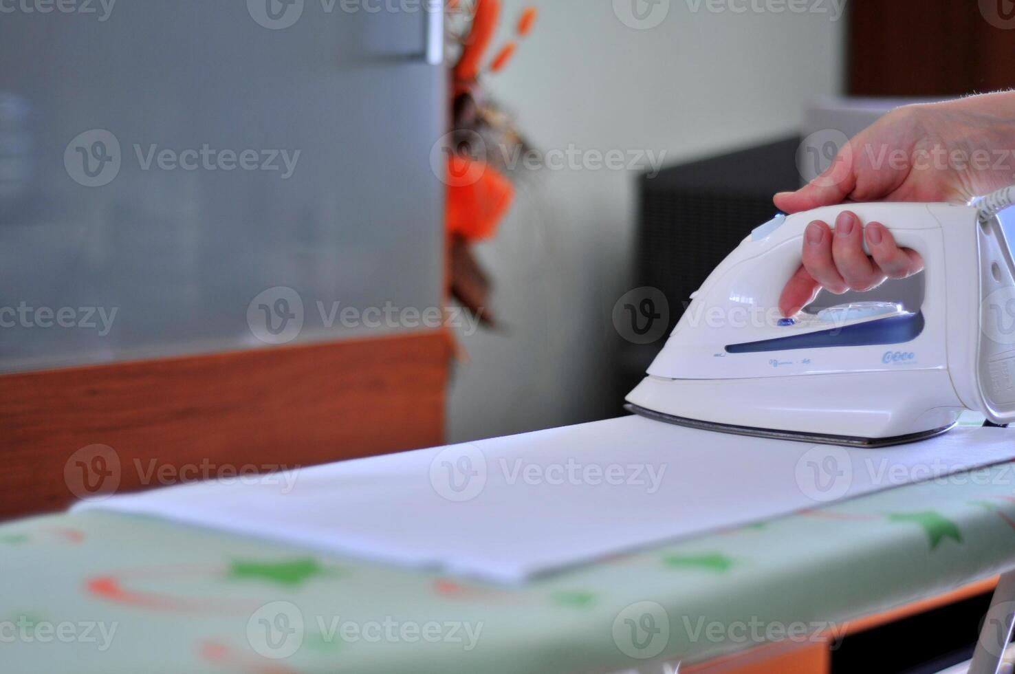 Woman hand ironing photo