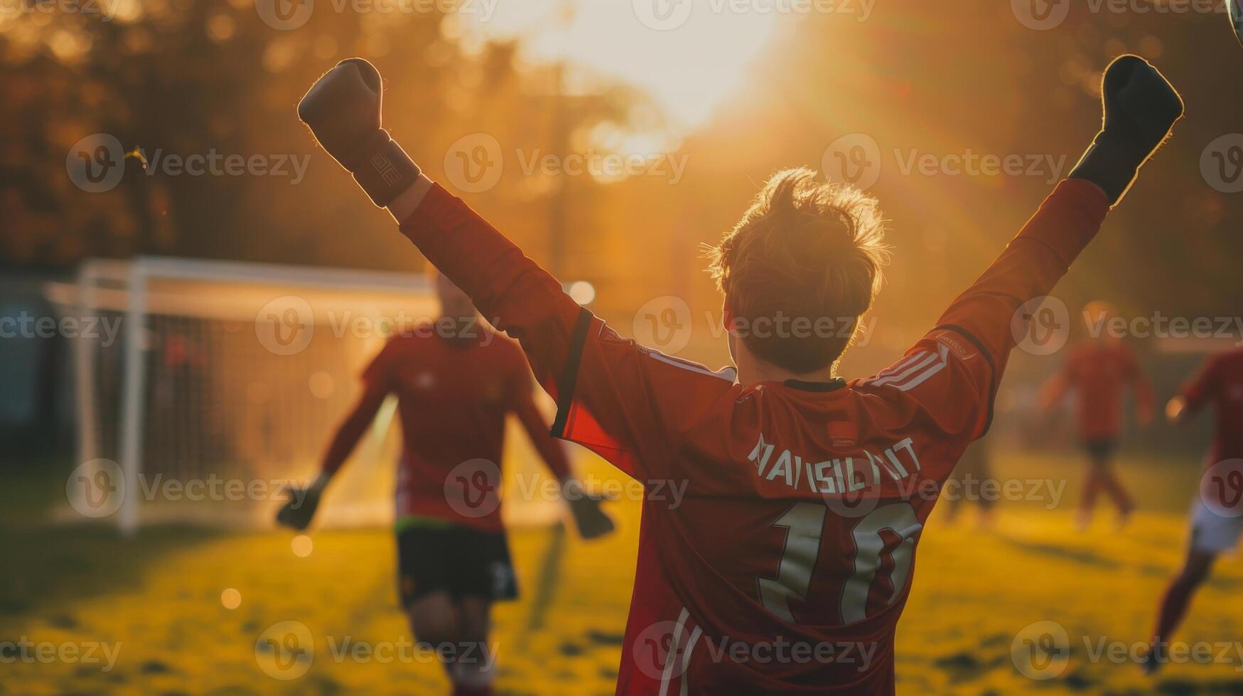 AI generated The celebration of a player as they watch the ball they've just shot fly towards the goal, arms raised in anticipation, the goal and the keeper in the background photo