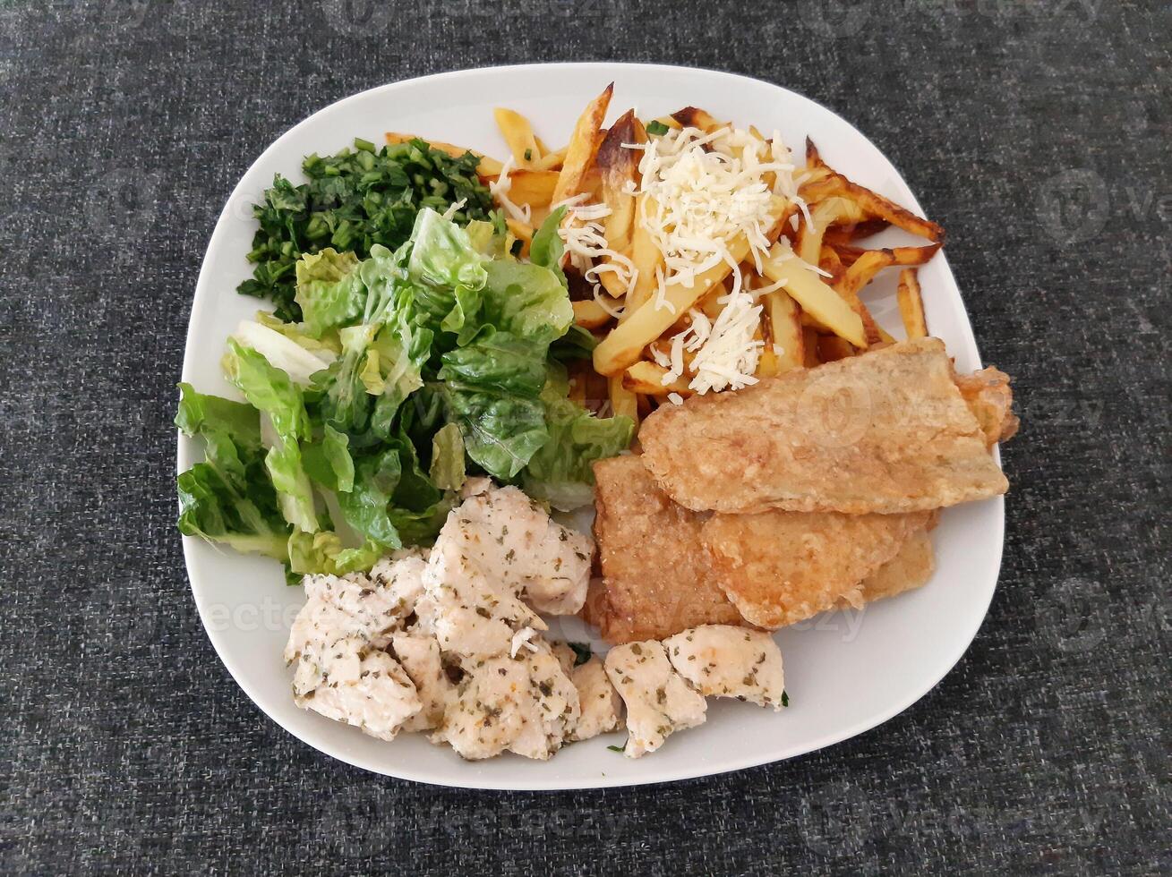 Homemade grilled chicken with grilled zucchini, green salad, french fries, cheese and parsley photo