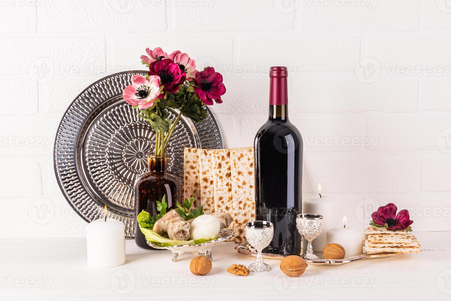 The concept of Jewish Passover. Traditional kosher food for the holiday, flowers in a vase. A burning candle. festive still life for holiday. photo